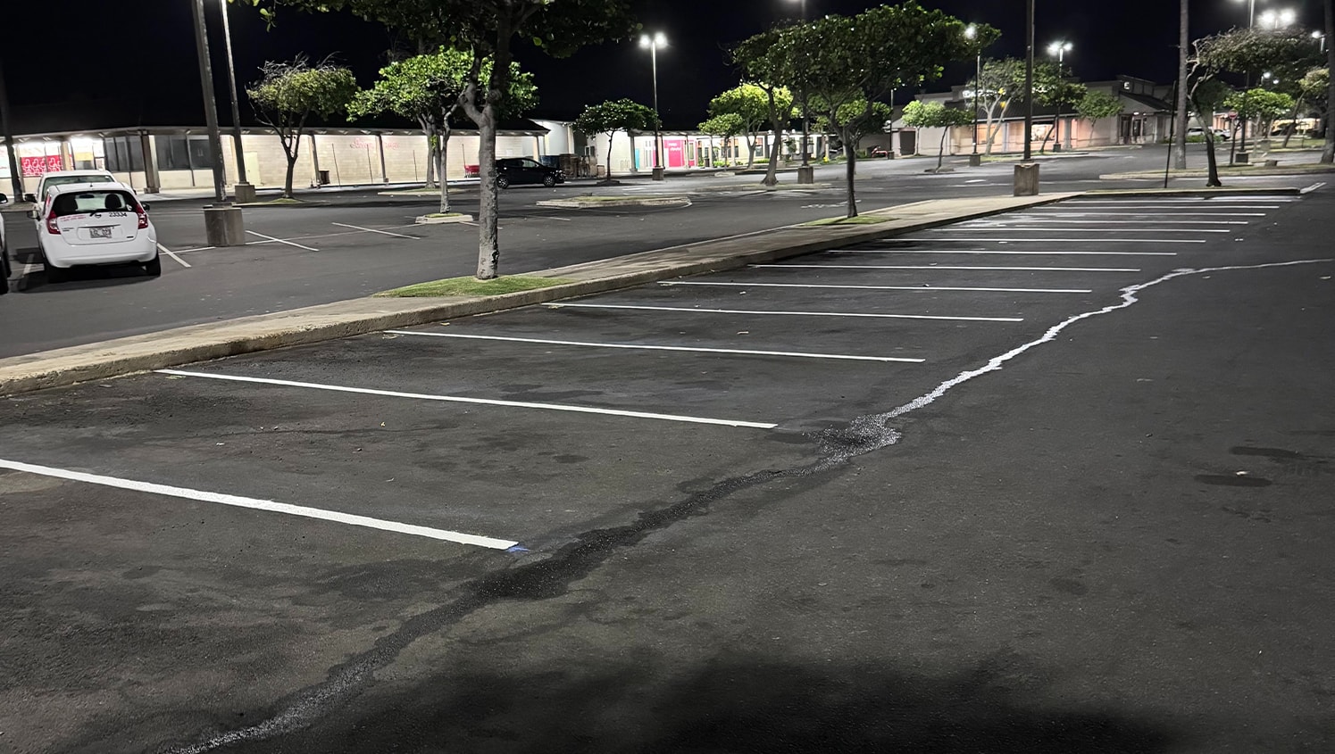 close-up of freshly painted parking spots for O'Reilly Auto Parts at dusk